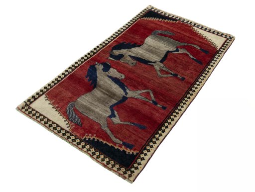 Corner detail of 2000s Persian Gabbeh rug showing border pattern and Wool pile