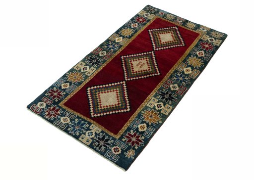 Corner detail of 2000s Persian Gabbeh rug showing border pattern and Wool pile