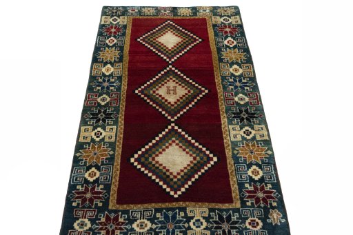 Surface texture of 2000s Persian Gabbeh rug with natural Wool and intricate pattern