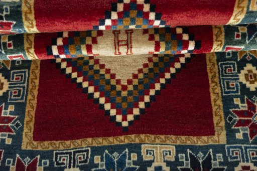 Full view of 2000s Persian Gabbeh rug from Iran / Persia, 156 × 83 cm in Red tones