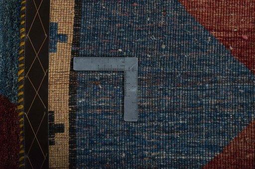 Corner detail of 2000s Persian Gabbeh rug showing border pattern and Wool pile