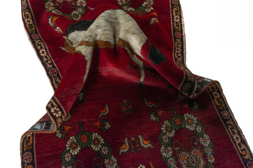 Corner detail of 2000s Persian Gabbeh rug showing border pattern and Wool pile