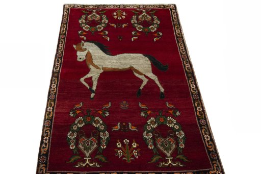 Surface texture of 2000s Persian Gabbeh rug with natural Wool and intricate pattern