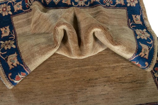 Corner detail of 2000s Persian Gabbeh rug showing border pattern and Wool pile