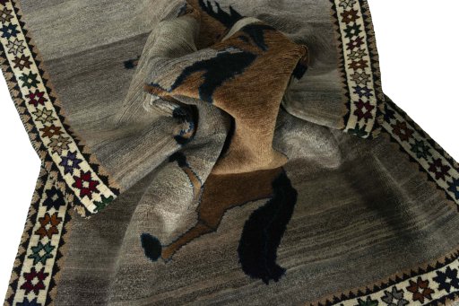 Corner detail of 2000s Persian Gabbeh rug showing border pattern and Wool pile