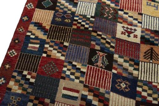 Backside of handmade 2000s Persian Gabbeh rug showing knot structure and weave density