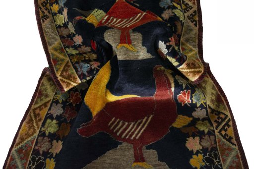 Corner detail of 2000s Persian Gabbeh rug showing border pattern and Wool pile