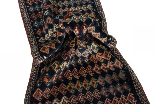Corner detail of 2000s Persian Gabbeh rug showing border pattern and Wool pile