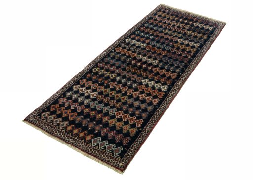 Corner detail of 2000s Persian Gabbeh rug showing border pattern and Wool pile