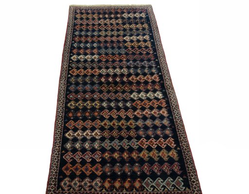 Surface texture of 2000s Persian Gabbeh rug with natural Wool and intricate pattern