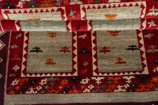 Full view of 2000s Persian Gabbeh rug from Iran / Persia, 190 × 107 cm in Beige tones