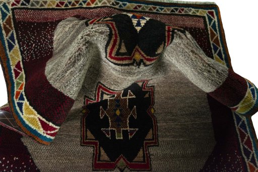 Corner detail of 2000s Persian Gabbeh rug showing border pattern and Wool pile