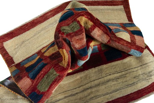 Corner detail of 2000s Persian Gabbeh rug showing border pattern and Wool pile
