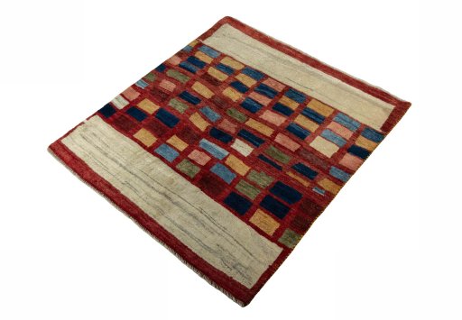Corner detail of 2000s Persian Gabbeh rug showing border pattern and Wool pile