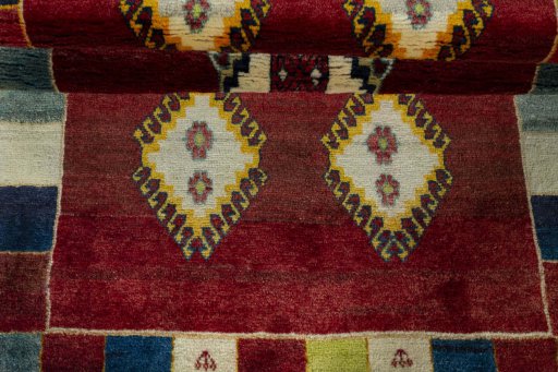 Full view of 2000s Persian Gabbeh rug from Iran / Persia, 193 × 104 cm in Red tones