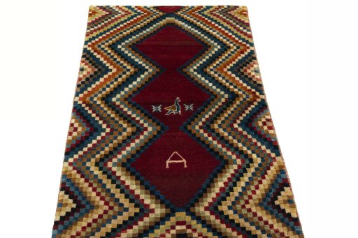 Surface texture of 2000s Persian Gabbeh rug with natural Wool and intricate pattern