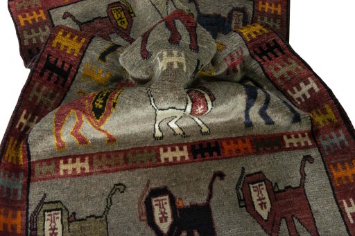 Corner detail of 2000s Persian Gabbeh rug showing border pattern and Wool pile