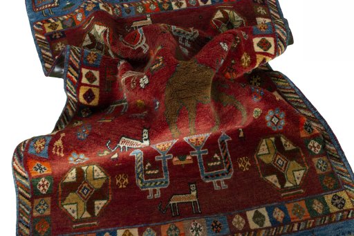 Corner detail of 2000s Persian Gabbeh rug showing border pattern and Wool pile
