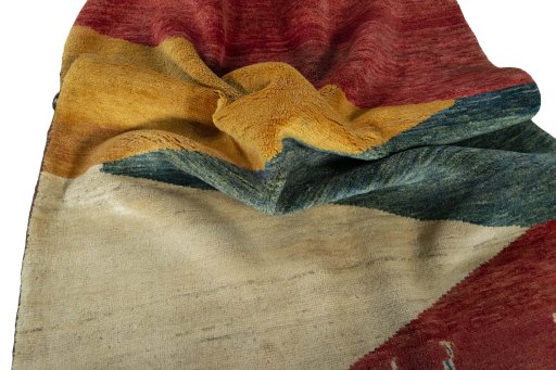 Corner detail of 2000s Persian Gabbeh rug showing border pattern and Wool pile