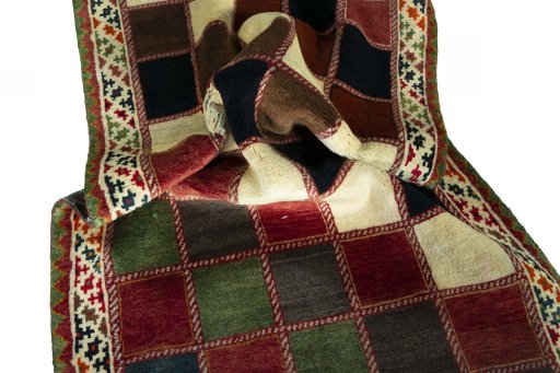 Corner detail of 2000s Persian Gabbeh rug showing border pattern and Wool pile