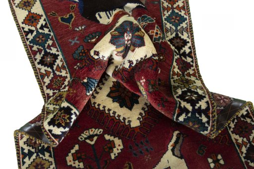 Corner detail of 2000s Persian Gabbeh rug showing border pattern and Wool pile