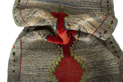 Corner detail of 2000s Persian Gabbeh rug showing border pattern and Wool pile