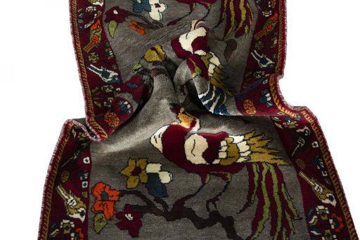 Corner detail of 2000s Persian Gabbeh rug showing border pattern and Wool pile