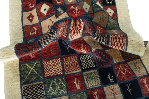 Corner detail of 2000s Persian Gabbeh rug showing border pattern and Wool pile