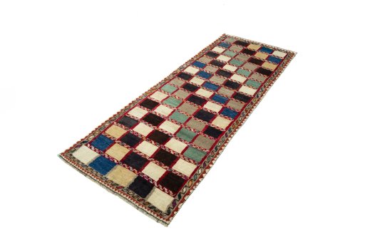 Corner detail of 2000s Persian Gabbeh rug showing border pattern and Wool pile