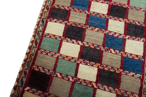 Backside of handmade 2000s Persian Gabbeh rug showing knot structure and weave density