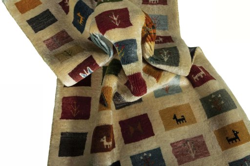 Corner detail of 2000s Persian Gabbeh rug showing border pattern and Wool pile