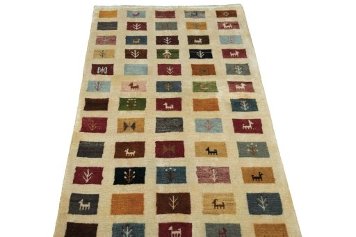 Surface texture of 2000s Persian Gabbeh rug with natural Wool and intricate pattern