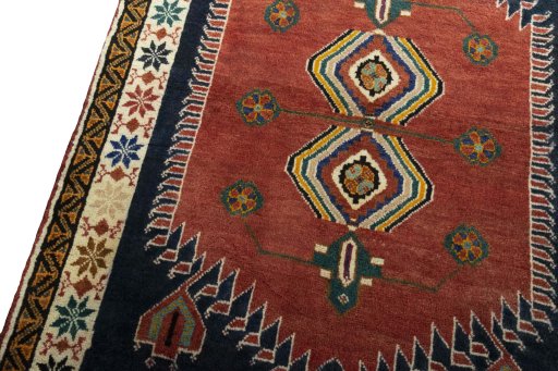 Backside of handmade 2000s Persian Gabbeh rug showing knot structure and weave density