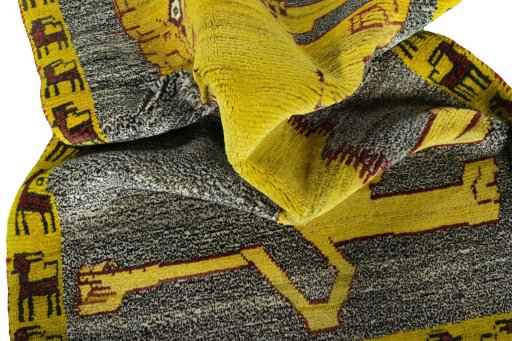 Corner detail of 2000s Persian Gabbeh rug showing border pattern and Wool pile