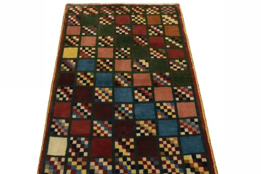 Surface texture of 2000s Persian Gabbeh rug with natural Wool and intricate pattern