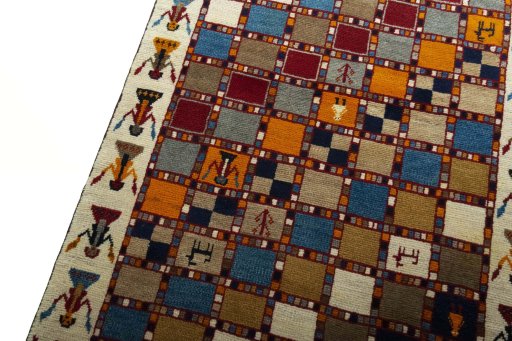 Backside of handmade 2000s Persian Gabbeh rug showing knot structure and weave density