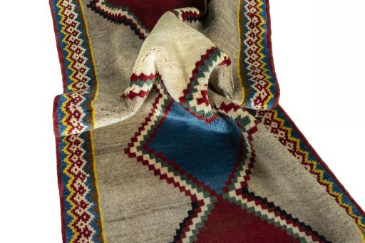 Corner detail of 2000s Persian Gabbeh rug showing border pattern and Wool pile