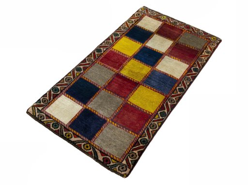 Corner detail of 2000s Persian Gabbeh rug showing border pattern and Wool pile