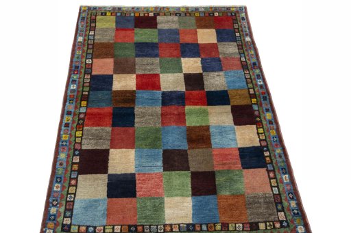 Surface texture of 2000s Persian Gabbeh rug with natural Wool and intricate pattern