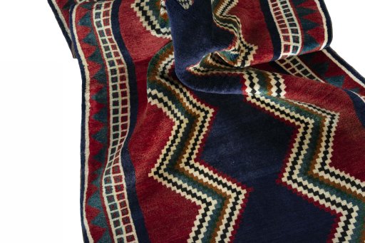 Corner detail of 2000s Persian Gabbeh rug showing border pattern and Wool pile