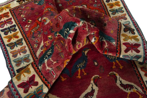 Corner detail of 2000s Persian Gabbeh rug showing border pattern and Wool pile