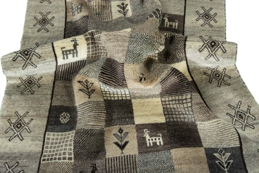 Corner detail of 2000s Persian Gabbeh rug showing border pattern and Wool pile