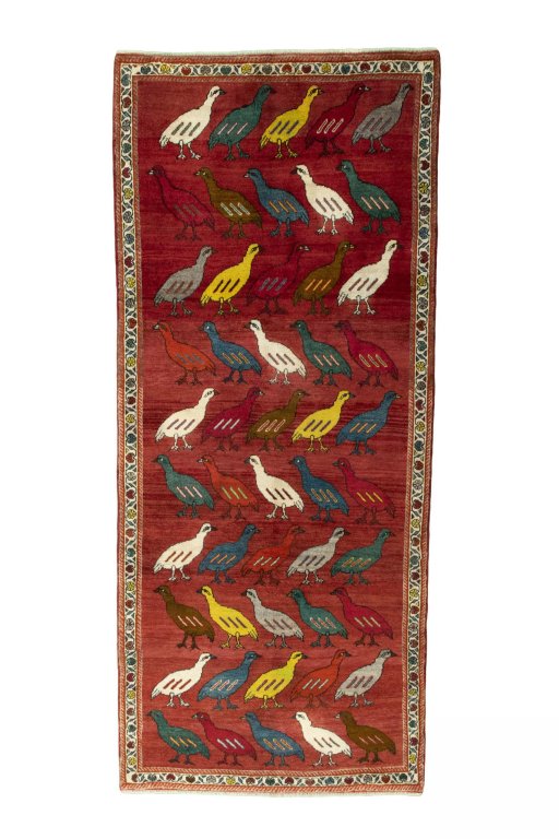 Full view of 2000s Persian Gabbeh rug from Iran / Persia, 296 × 127 cm in Red tones