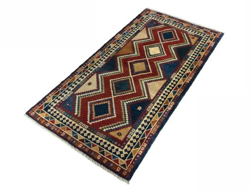 Corner detail of 2000s Persian Gabbeh rug showing border pattern and Wool pile