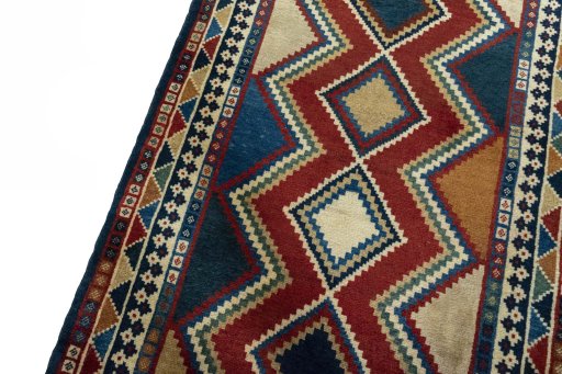 Backside of handmade 2000s Persian Gabbeh rug showing knot structure and weave density