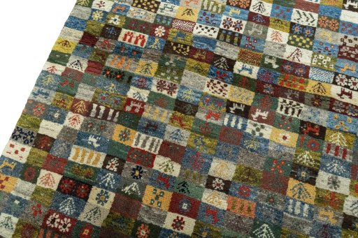 Backside of handmade 2000s Persian Gabbeh rug showing knot structure and weave density