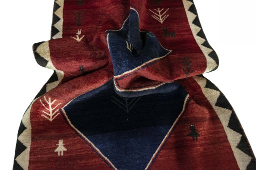 Corner detail of 2000s Persian Gabbeh rug showing border pattern and Wool pile