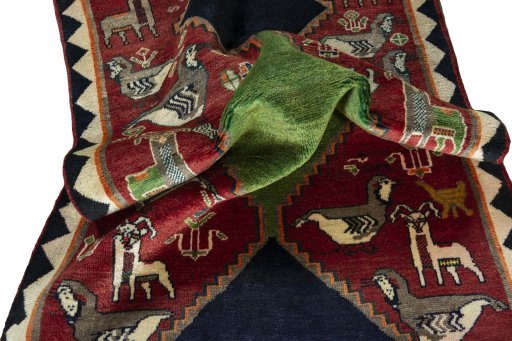 Corner detail of 2000s Persian Gabbeh rug showing border pattern and Wool pile