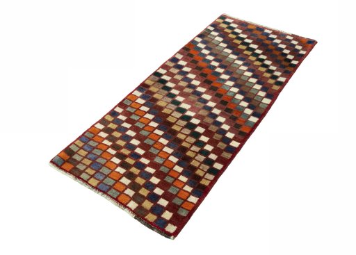 Corner detail of 2000s Persian Gabbeh rug showing border pattern and Wool pile