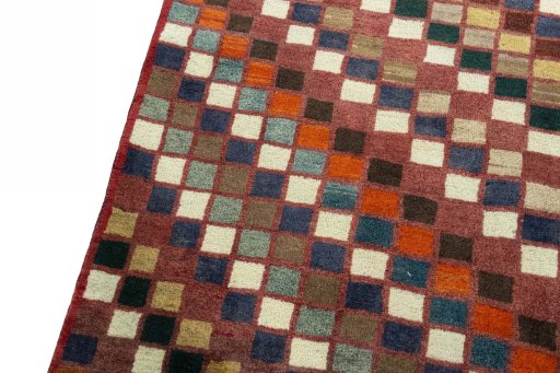 Backside of handmade 2000s Persian Gabbeh rug showing knot structure and weave density